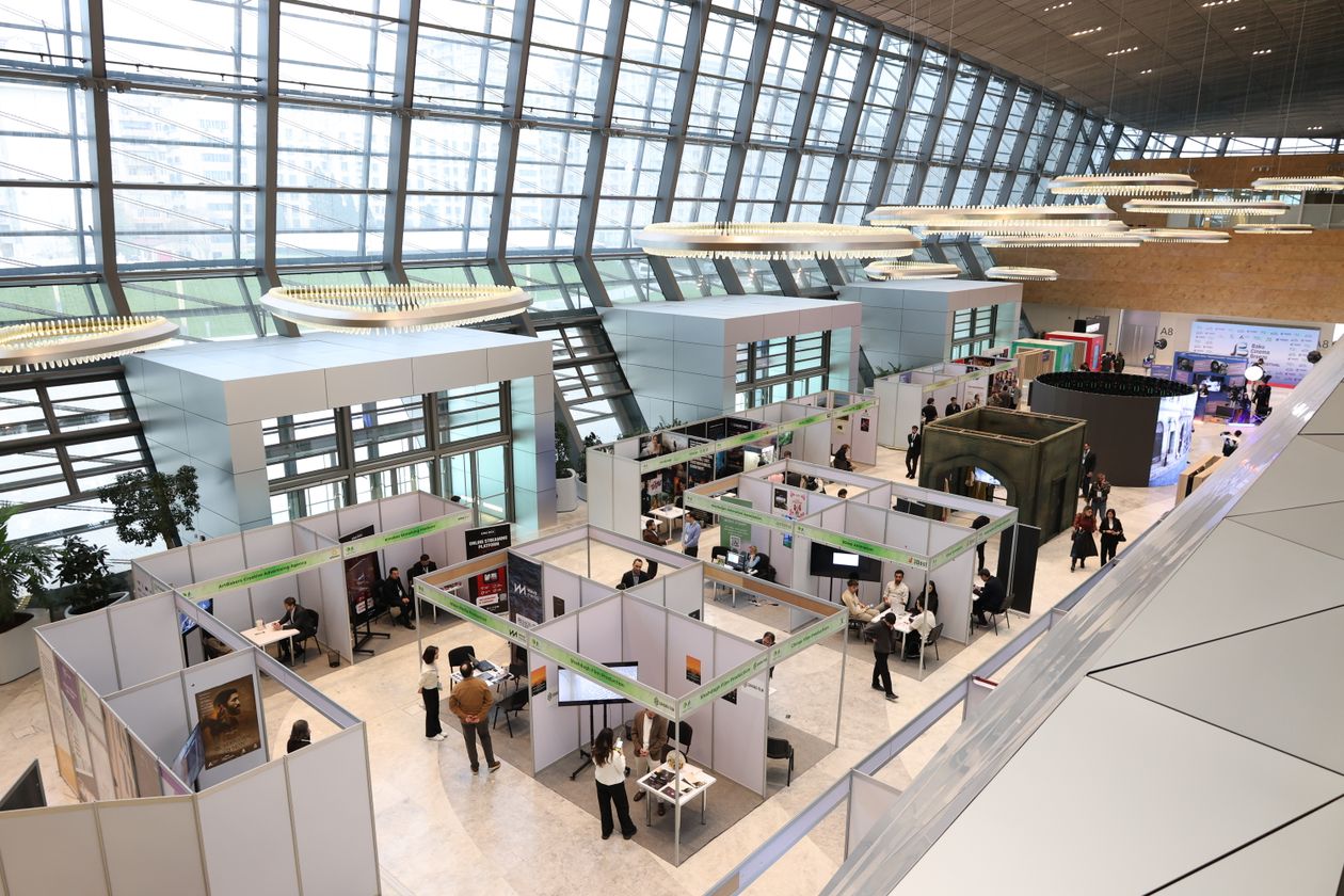 Busy trade show exhibition hall with attendees networking at display stands