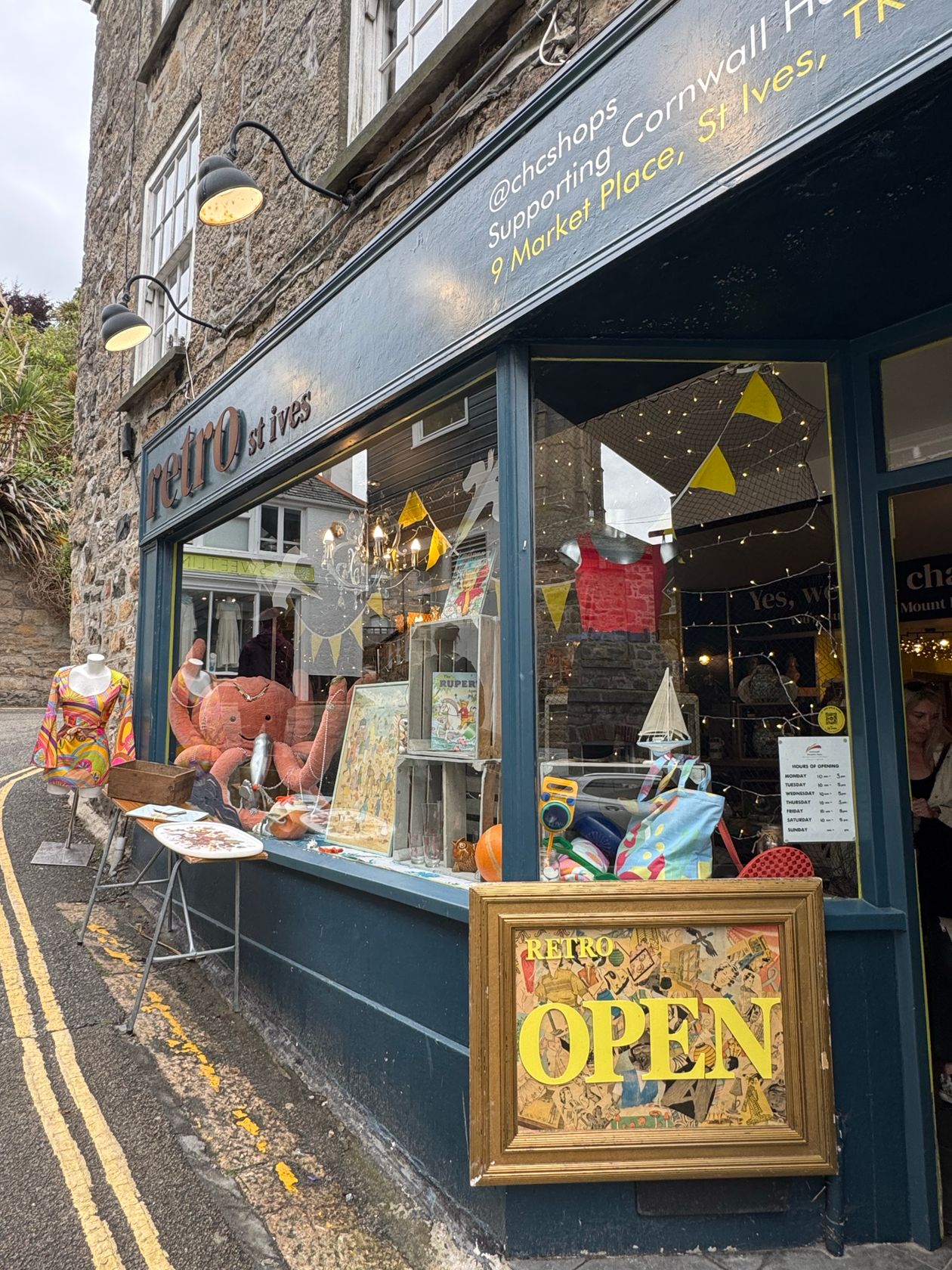 Retro vintage shop exterior in St Ives Cornwall with eclectic window display and signage