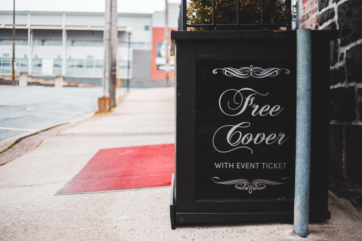 A-frame pavement sign standing on a street outside a venue entrance
