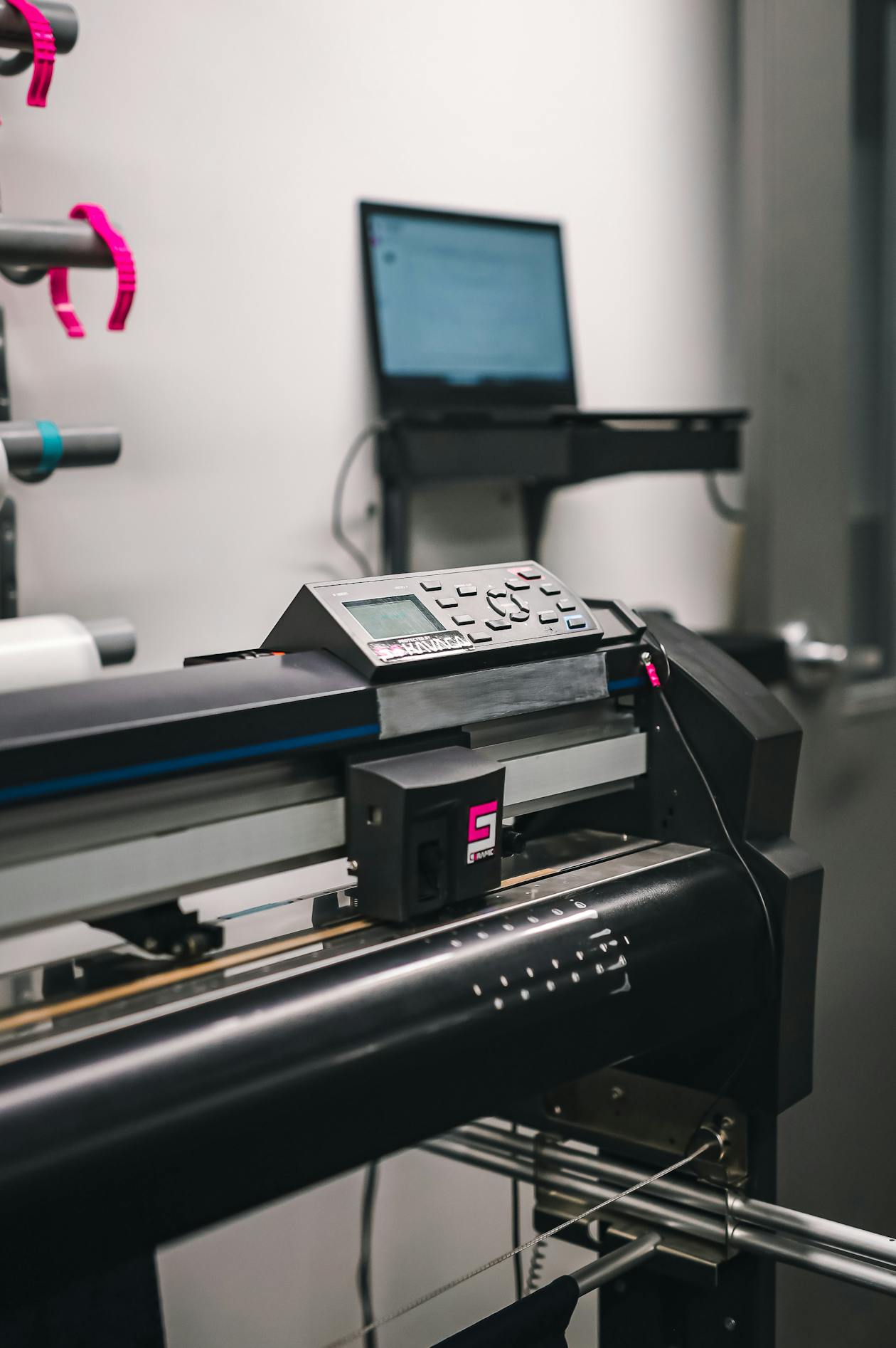 Close-up of a large format printing machine running a banner print job in a professional studio