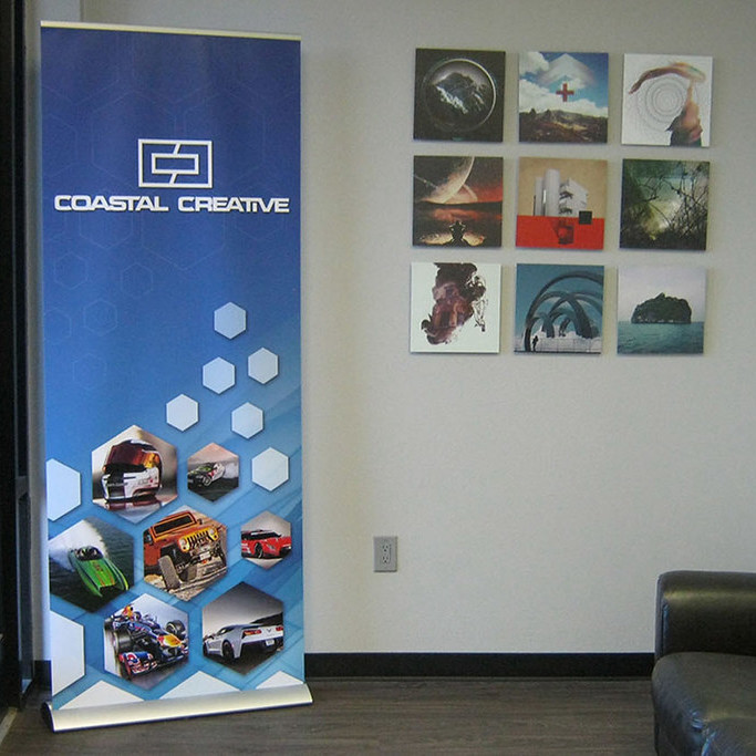 Coastal Creative roller banner pull-up stand in an office reception area