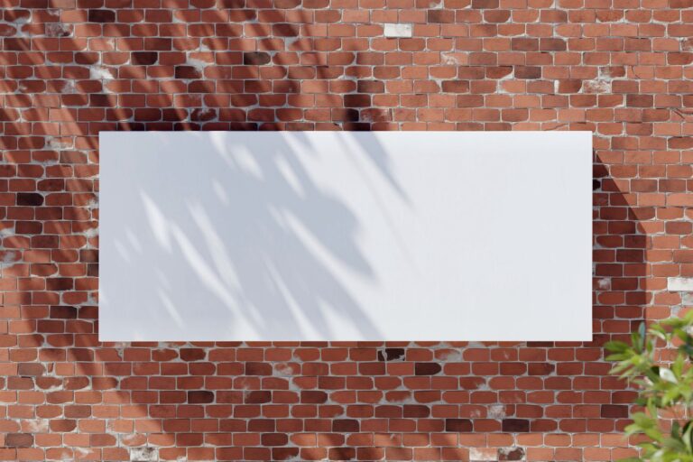 Blank poster mockup on an exterior brick wall
