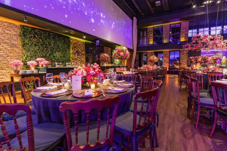 Gala event space with floral table displays and ambient lighting