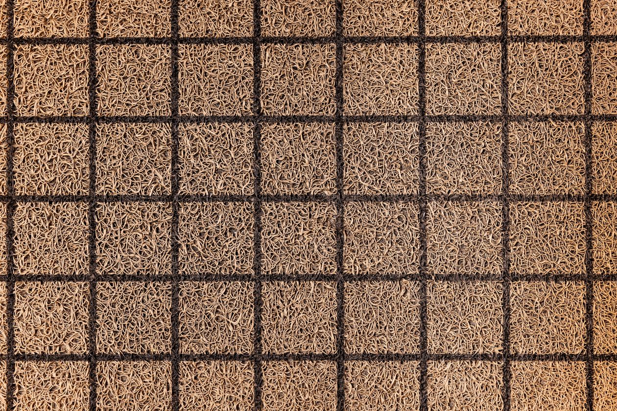Close-up texture of a woven coir entrance mat