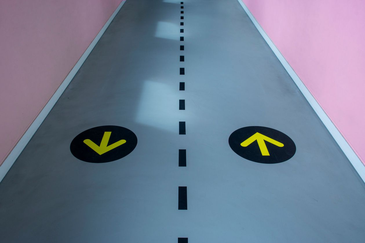 Colourful printed directional floor arrows in a venue walkway