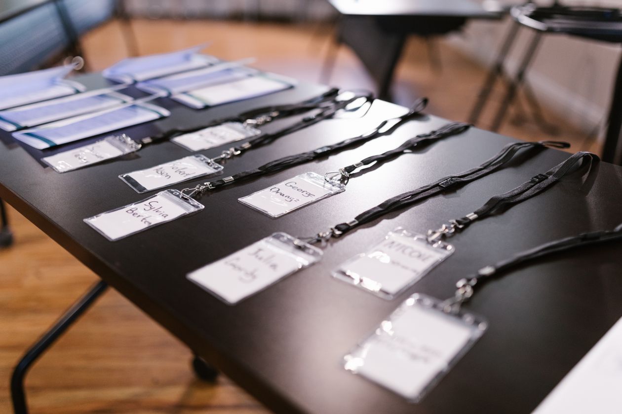 Conference name badges and lanyards laid out on a table