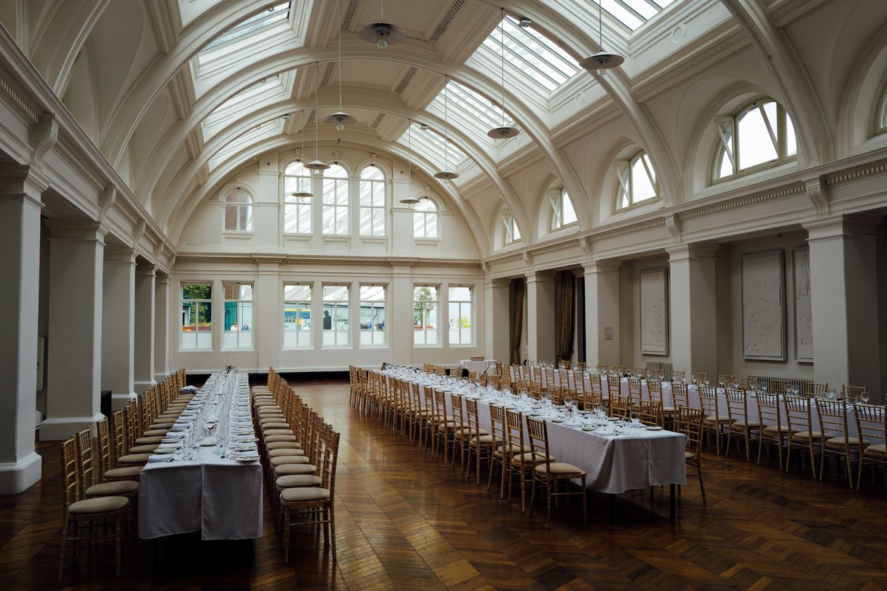 Grand hall with long tables set for a wedding reception