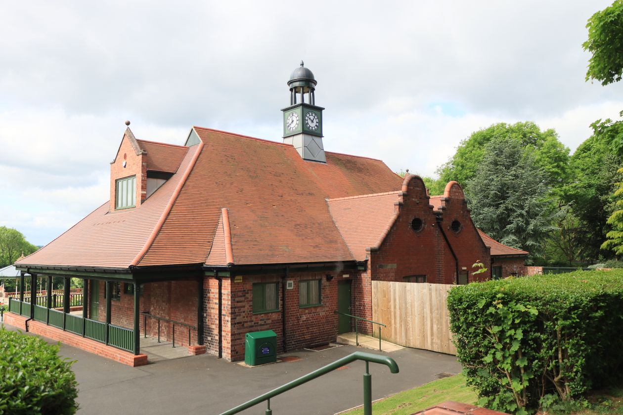 English brick park pavilion building with a clock tower