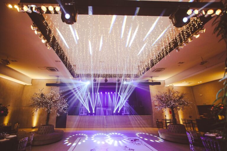 Upscale event venue with decorative stage lighting, empty seating