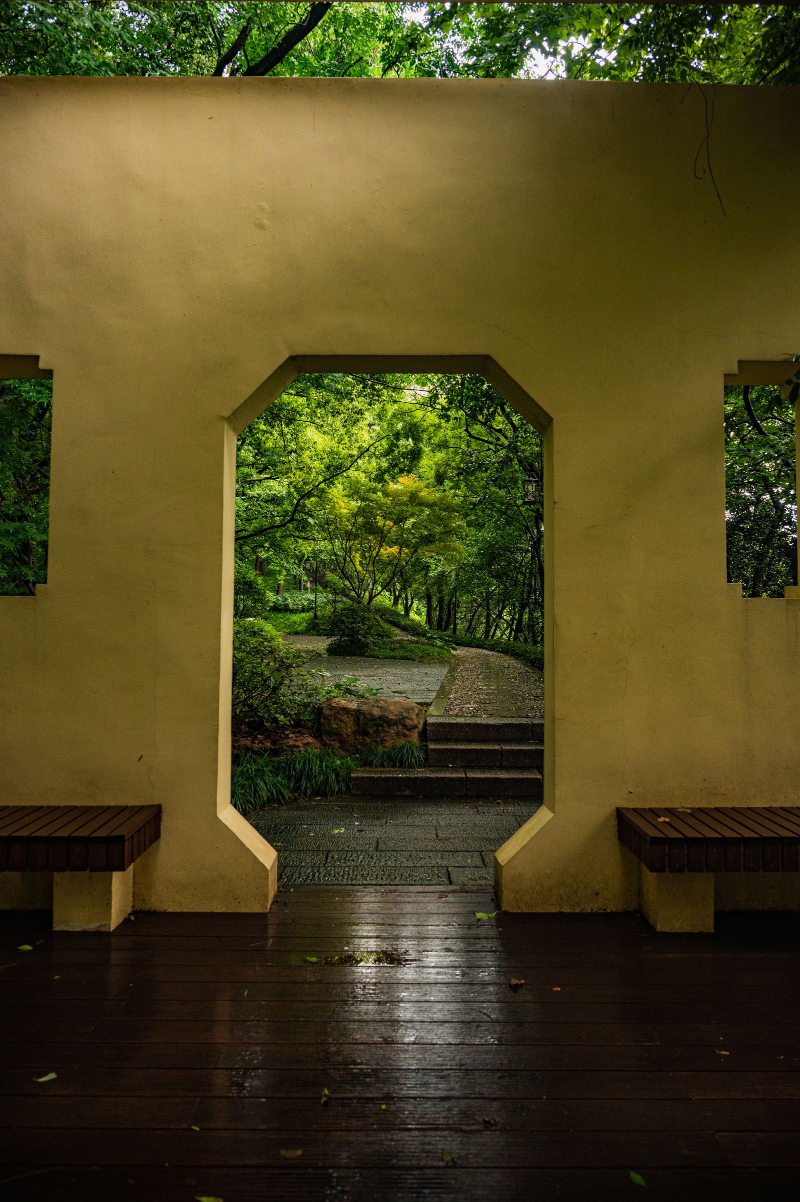 Serene garden view through a stone archway