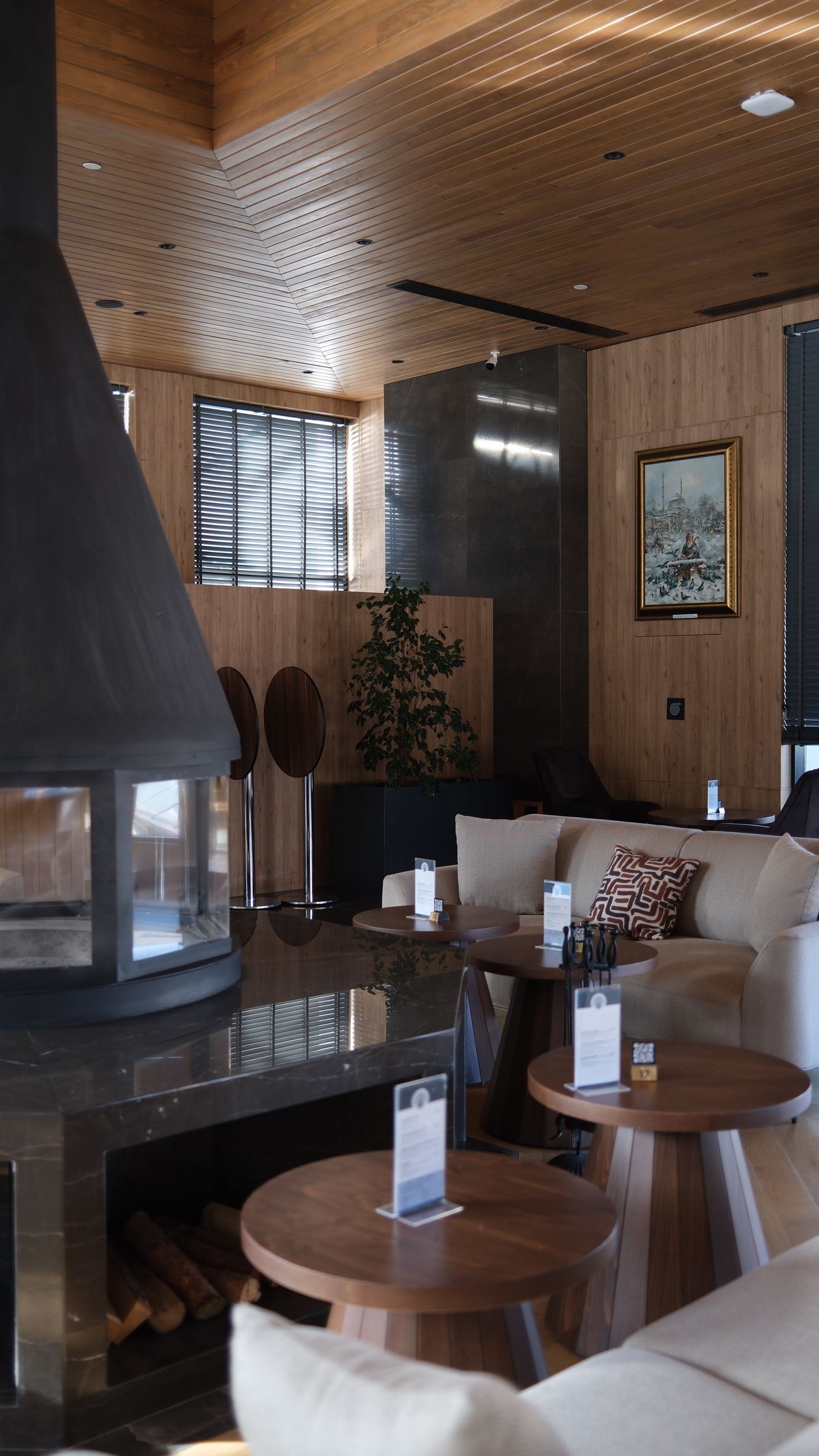 Warm wood-panelled clubhouse lounge with seating and side tables