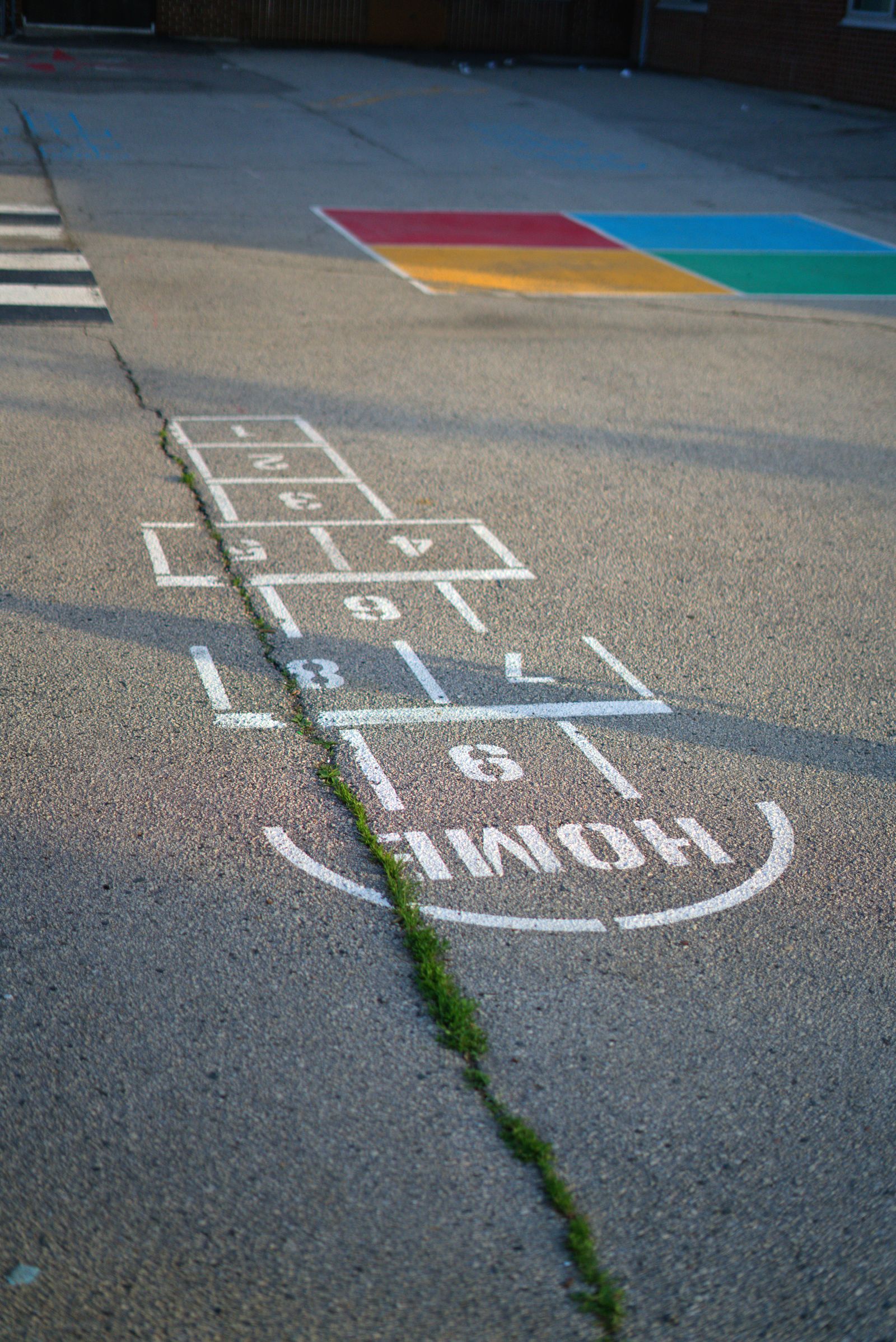 Colourful hopscotch pattern painted on a concrete playground floor