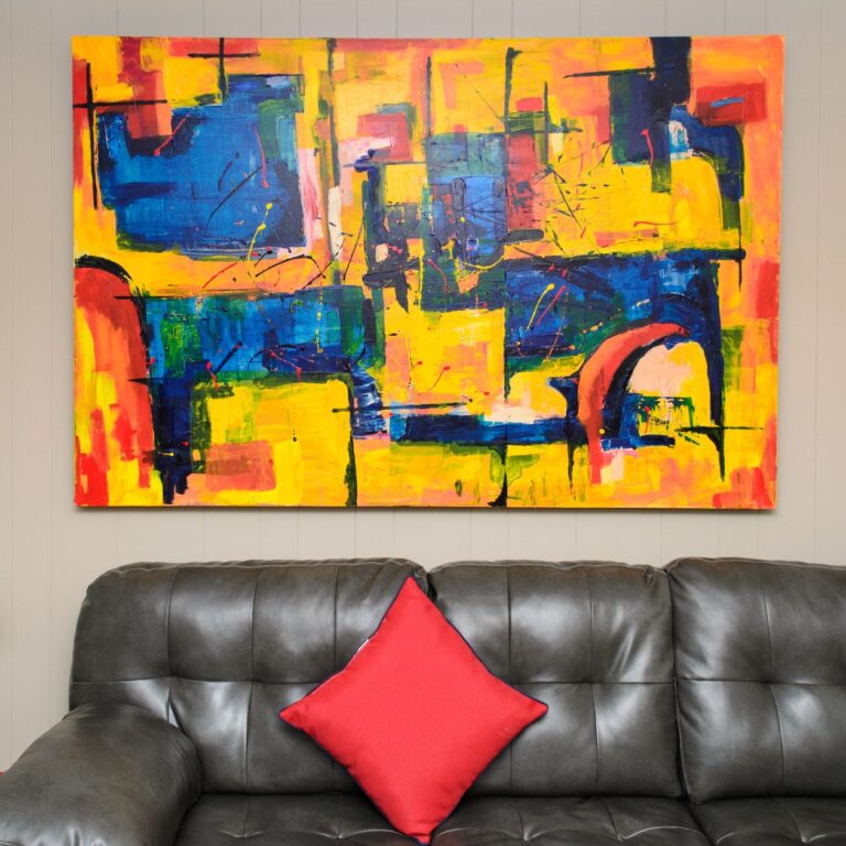 Large abstract canvas print above a leather sofa