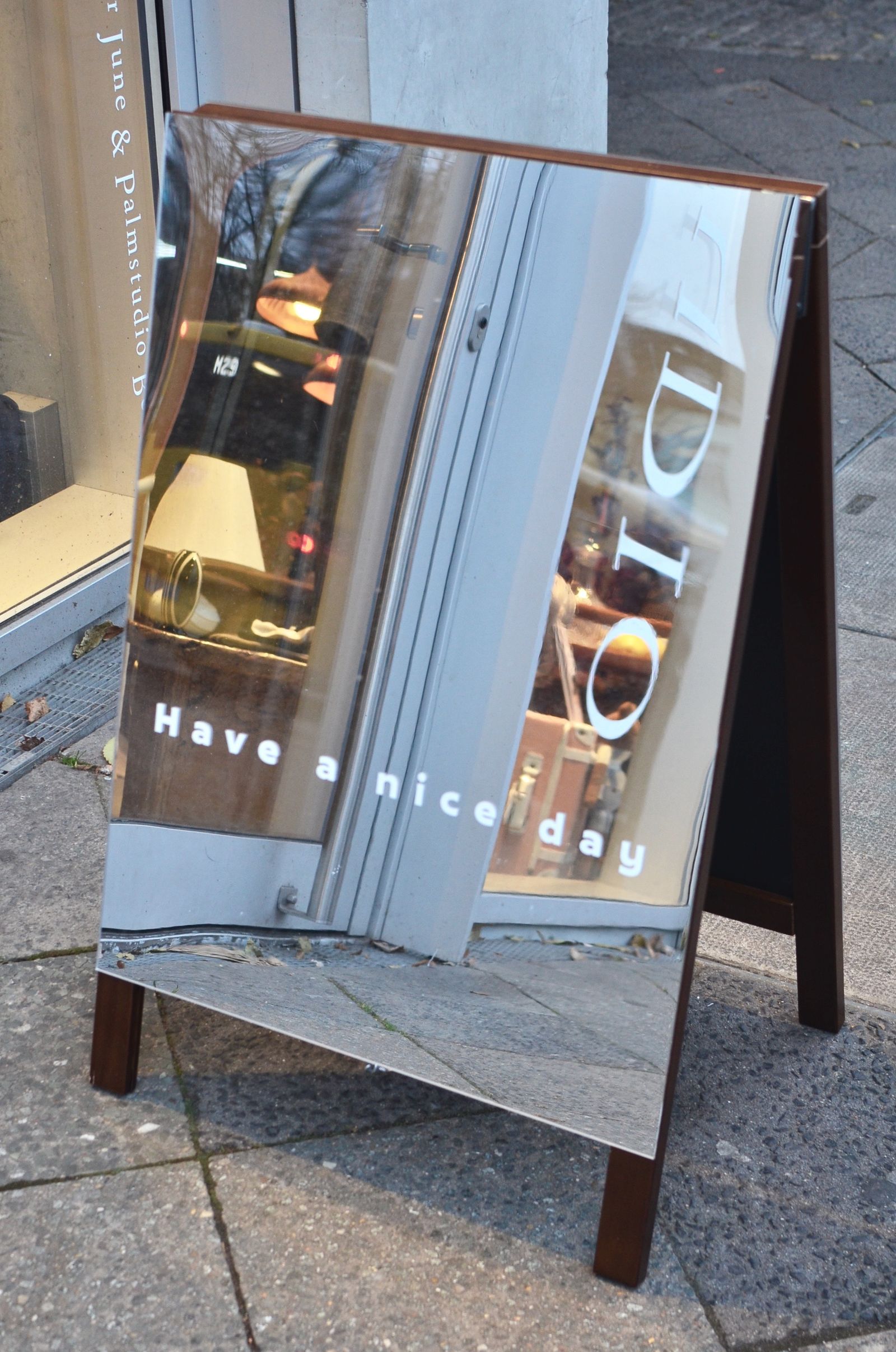 Mirrored A-frame pavement sign on a city street
