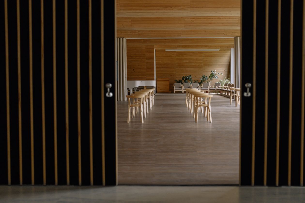 Modern minimalist hall interior with rows of wooden chairs