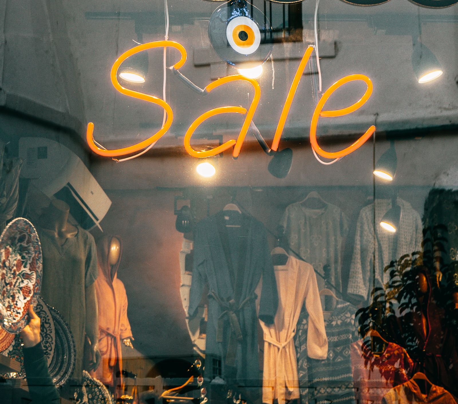 Illuminated neon sale sign in a boutique window