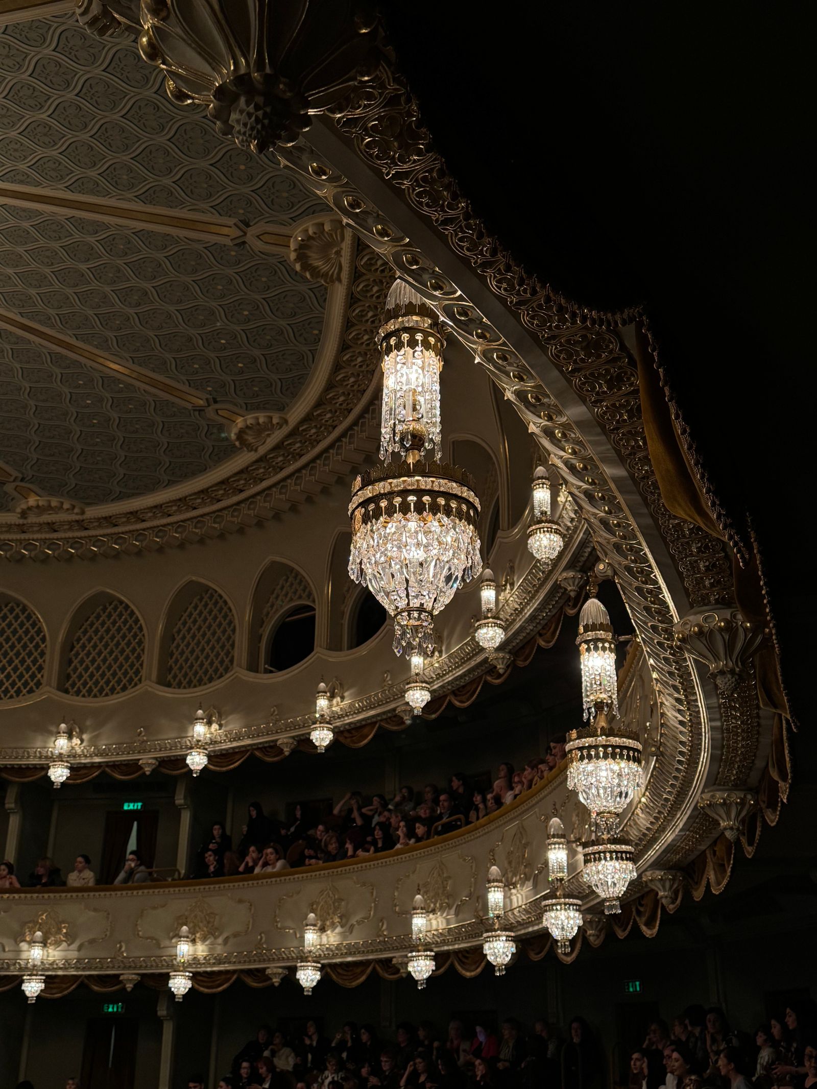 Ornate theatre interior with grand chandeliers