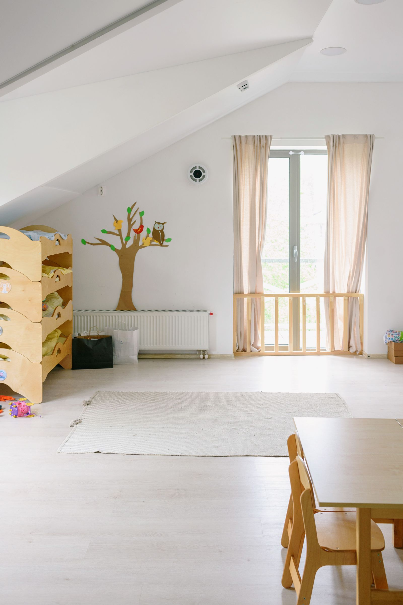 Contemporary children's room in pastel tones with wooden furniture