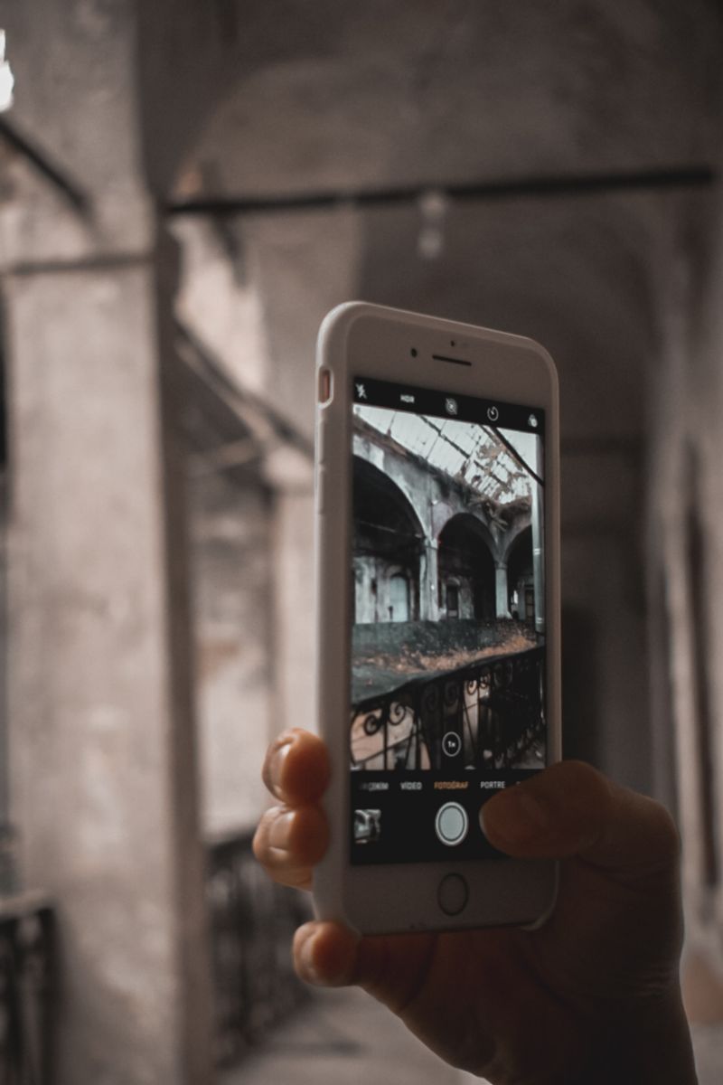 Smartphone photographing an archway interior for a signage brief
