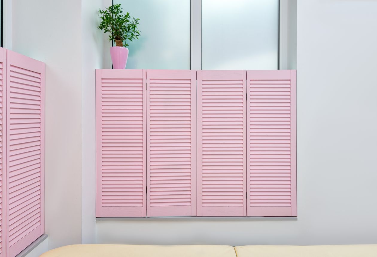 Salon window with pink shutters providing privacy and light