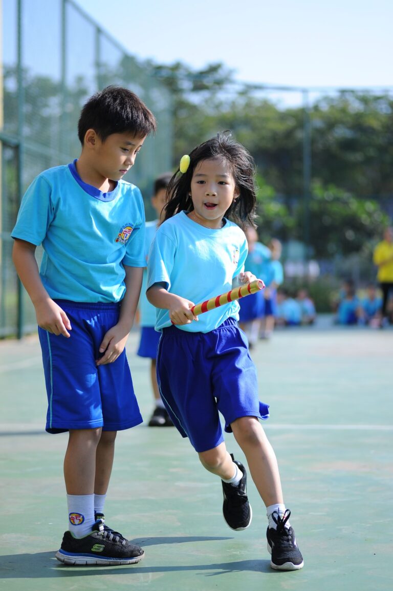 Schoolchildren taking part in a relay race on a playground
