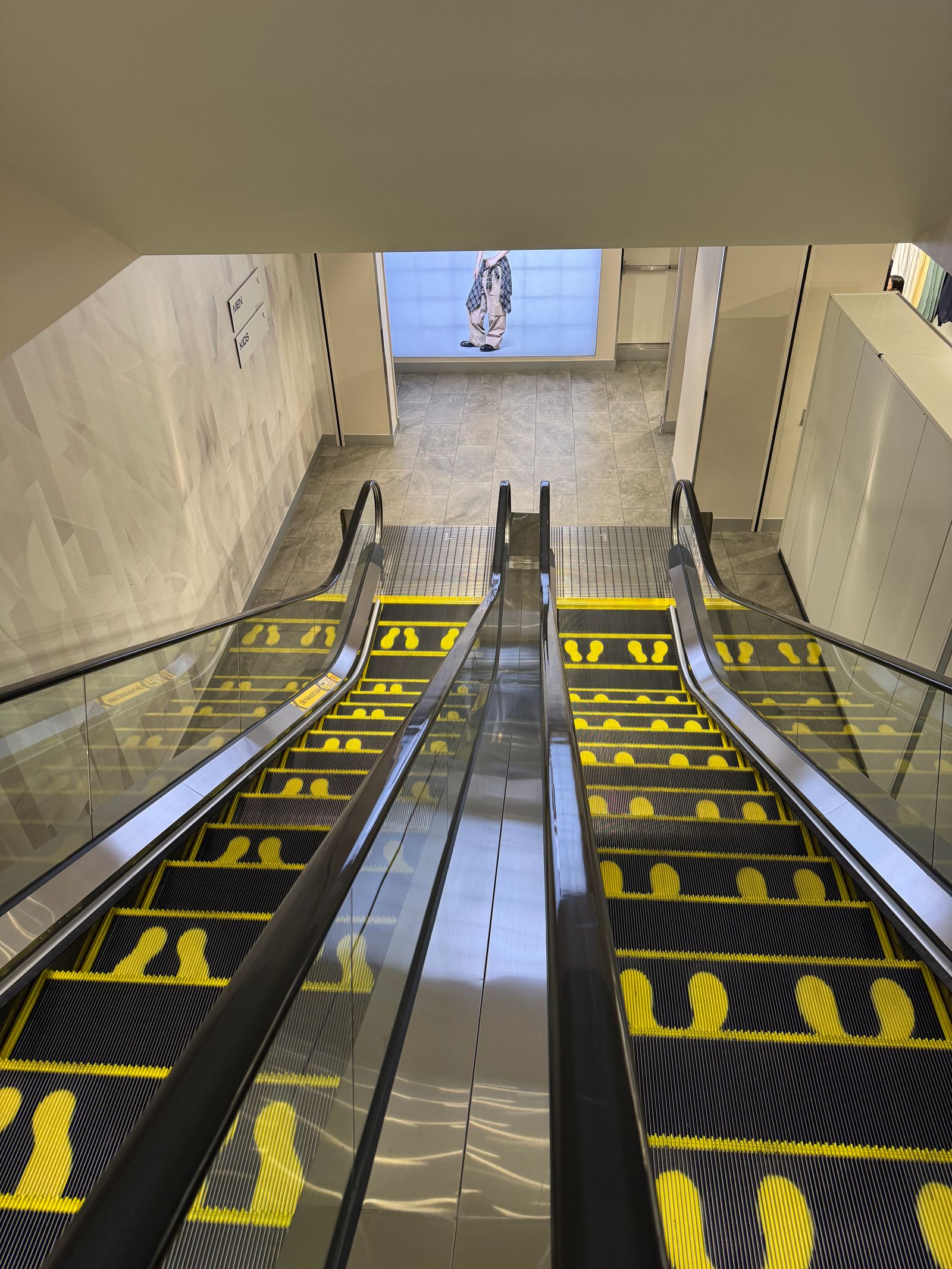 Shopping mall floor with yellow directional floor markings