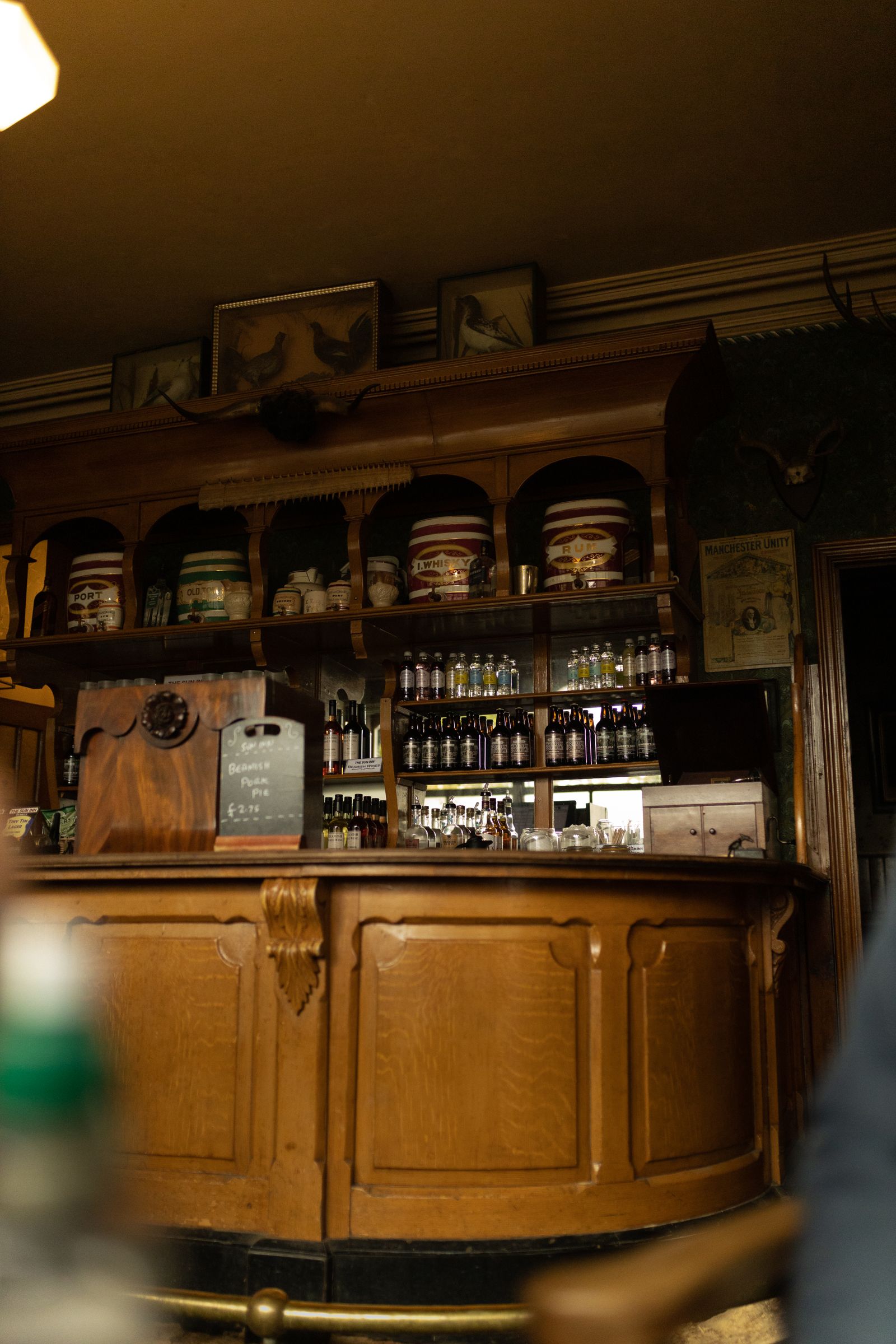 Elegant vintage bar interior with a wooden counter and bottle shelving