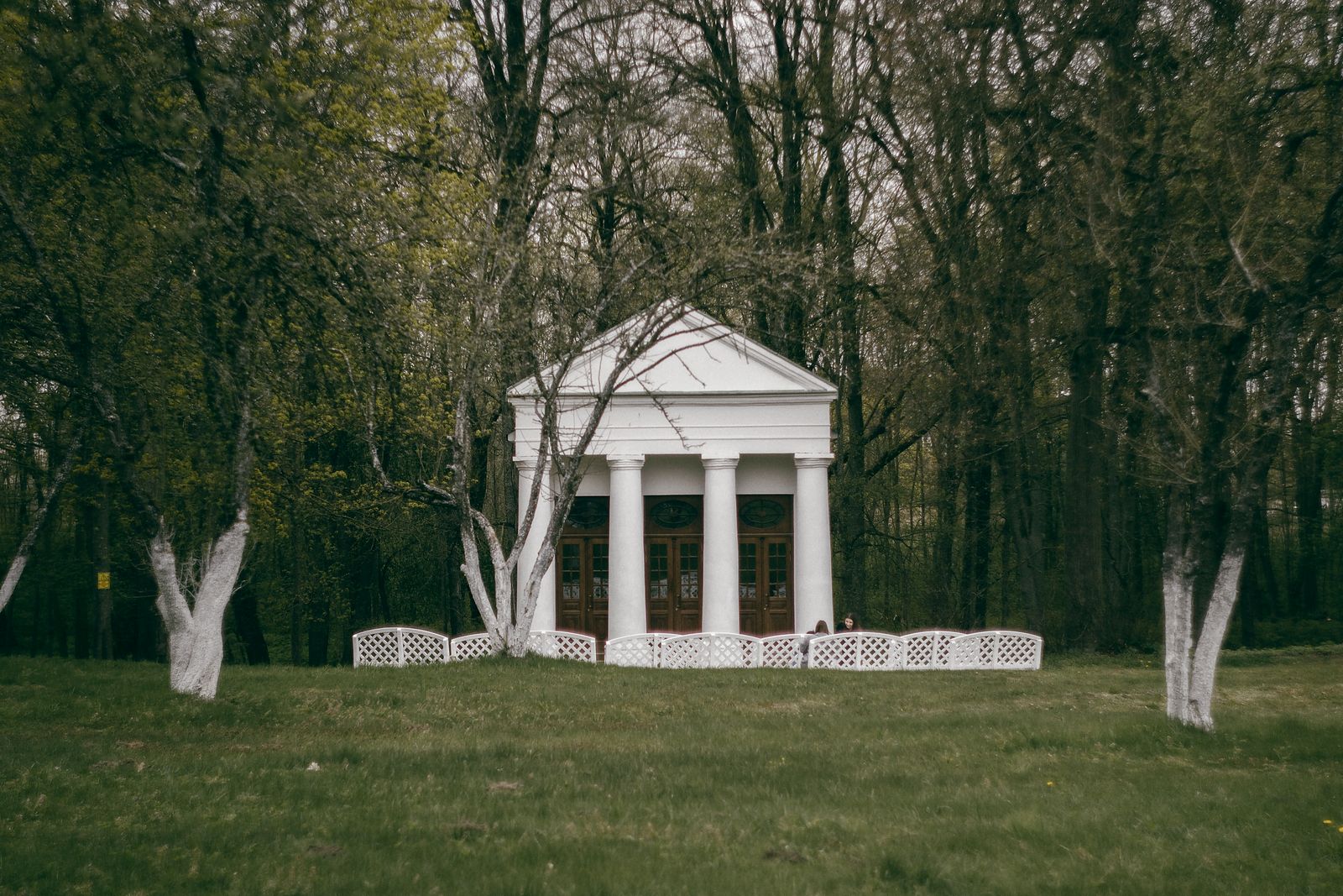 White pavilion building in a countryside setting