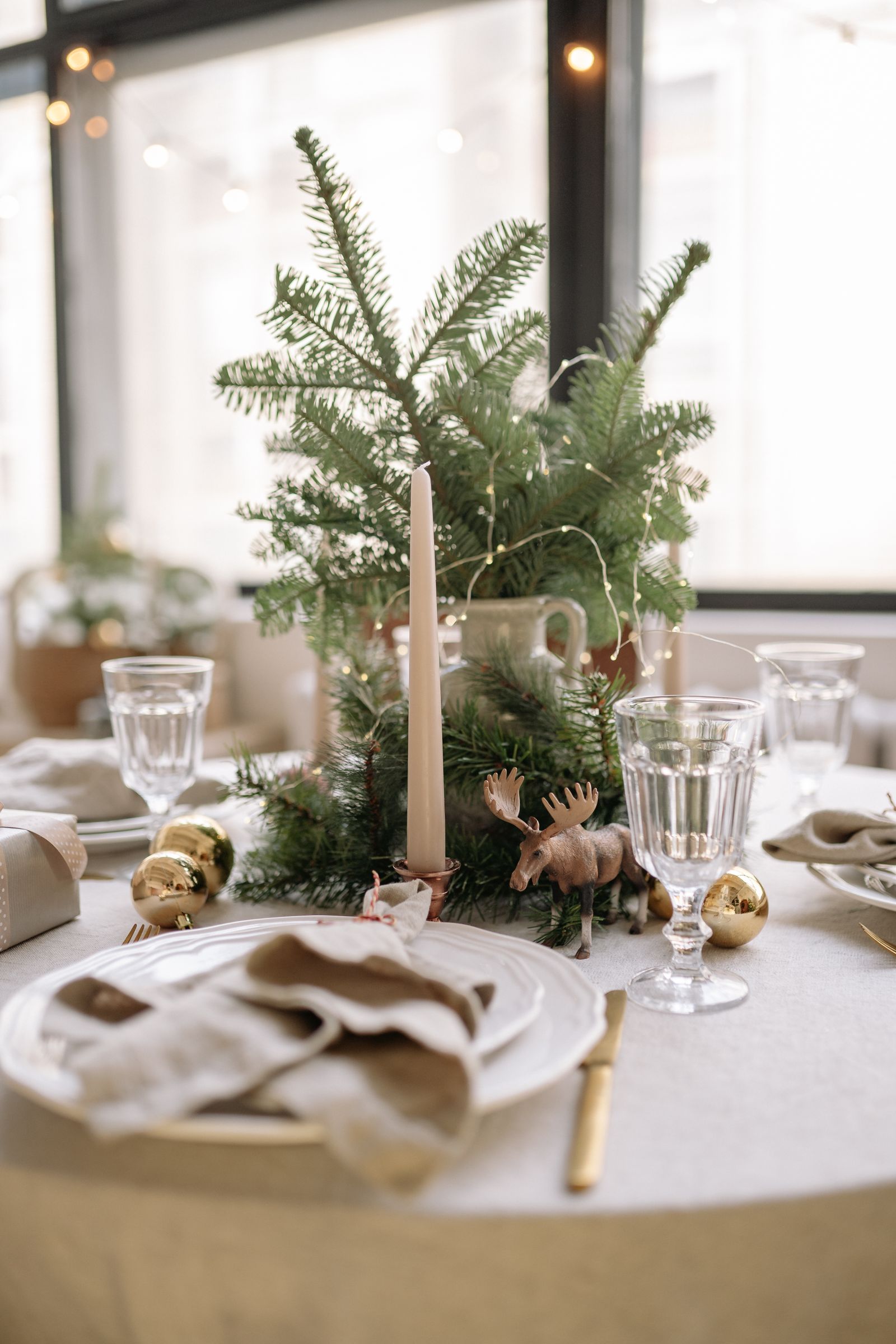 Elegant Christmas table with white tablecloth and gold accents