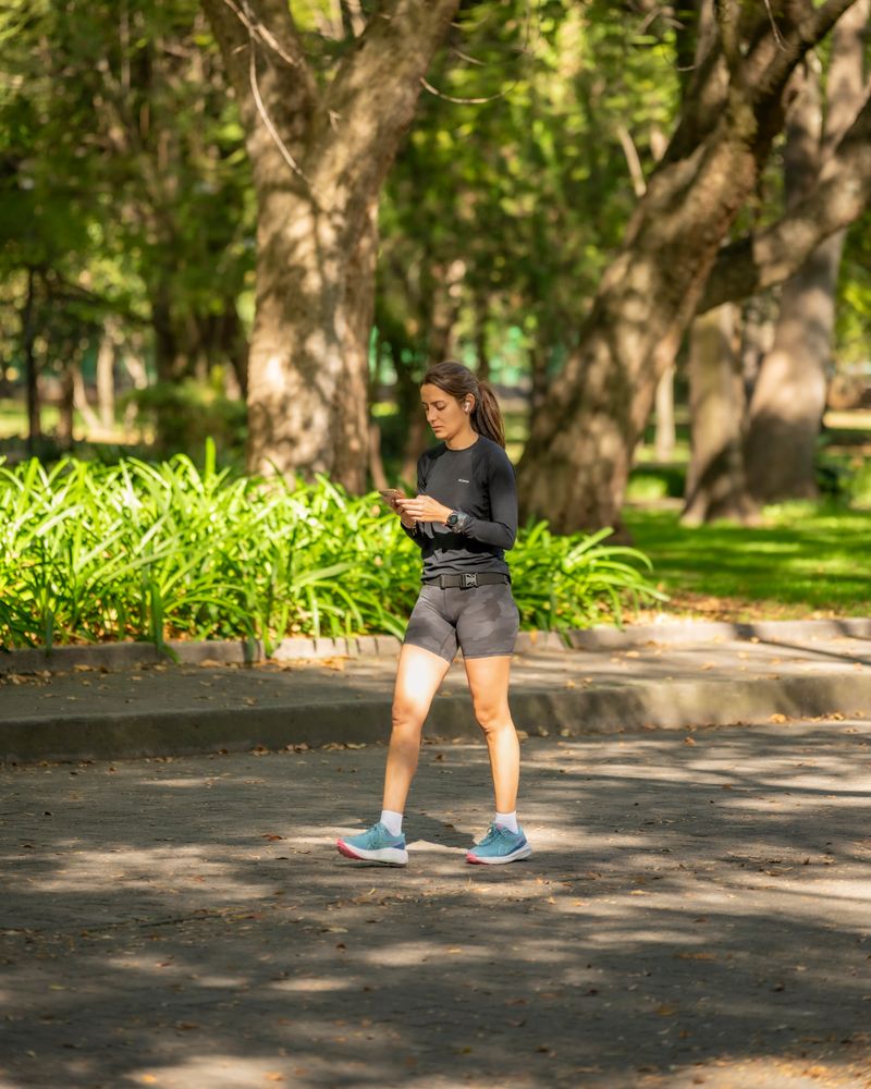 Woman jogging alone on a shaded park path