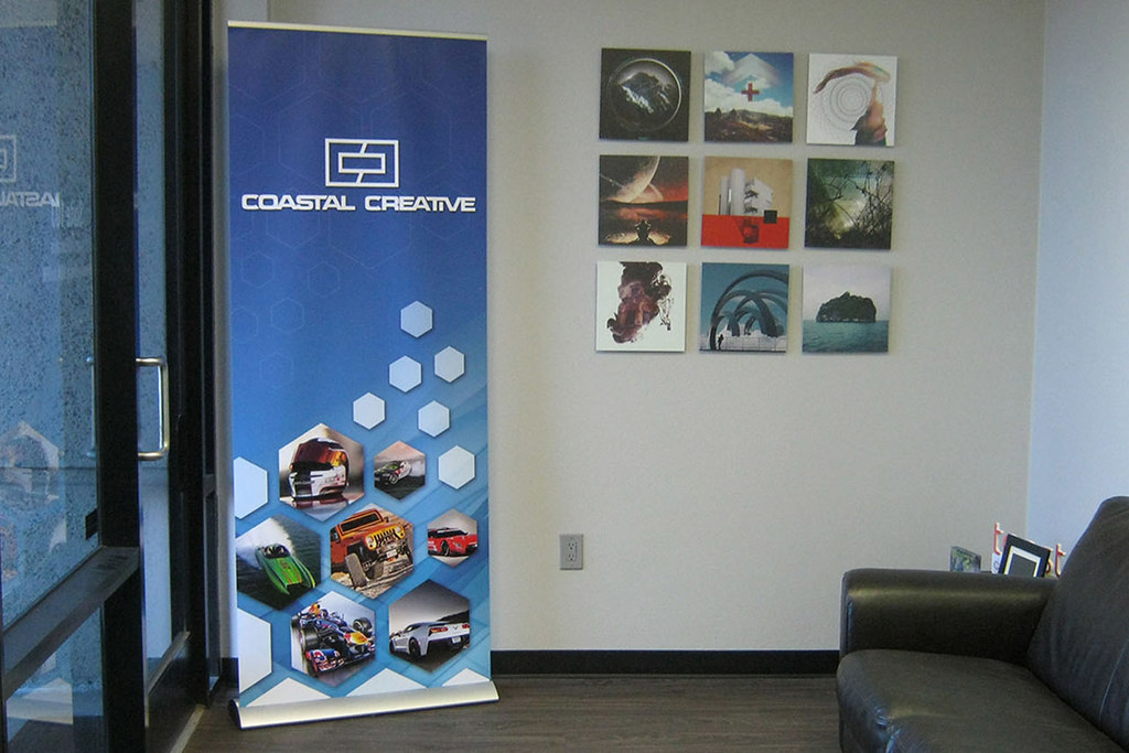 Pull-up roller banner stand displaying branded graphics in a professional indoor setting