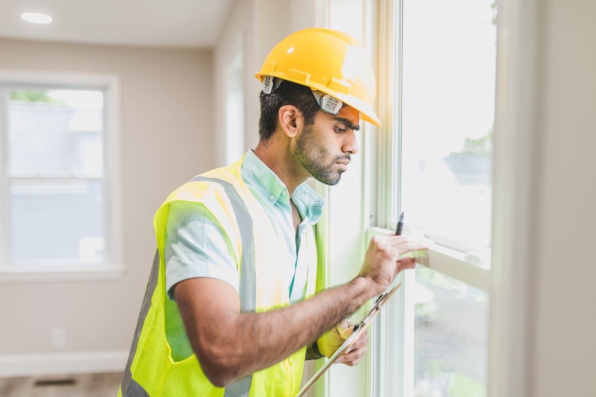 Construction worker wearing a yellow hi-vis safety vest and hard hat